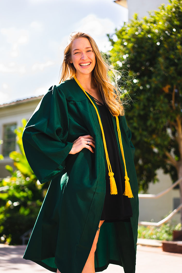 Cal Poly grad in gown poses confidently